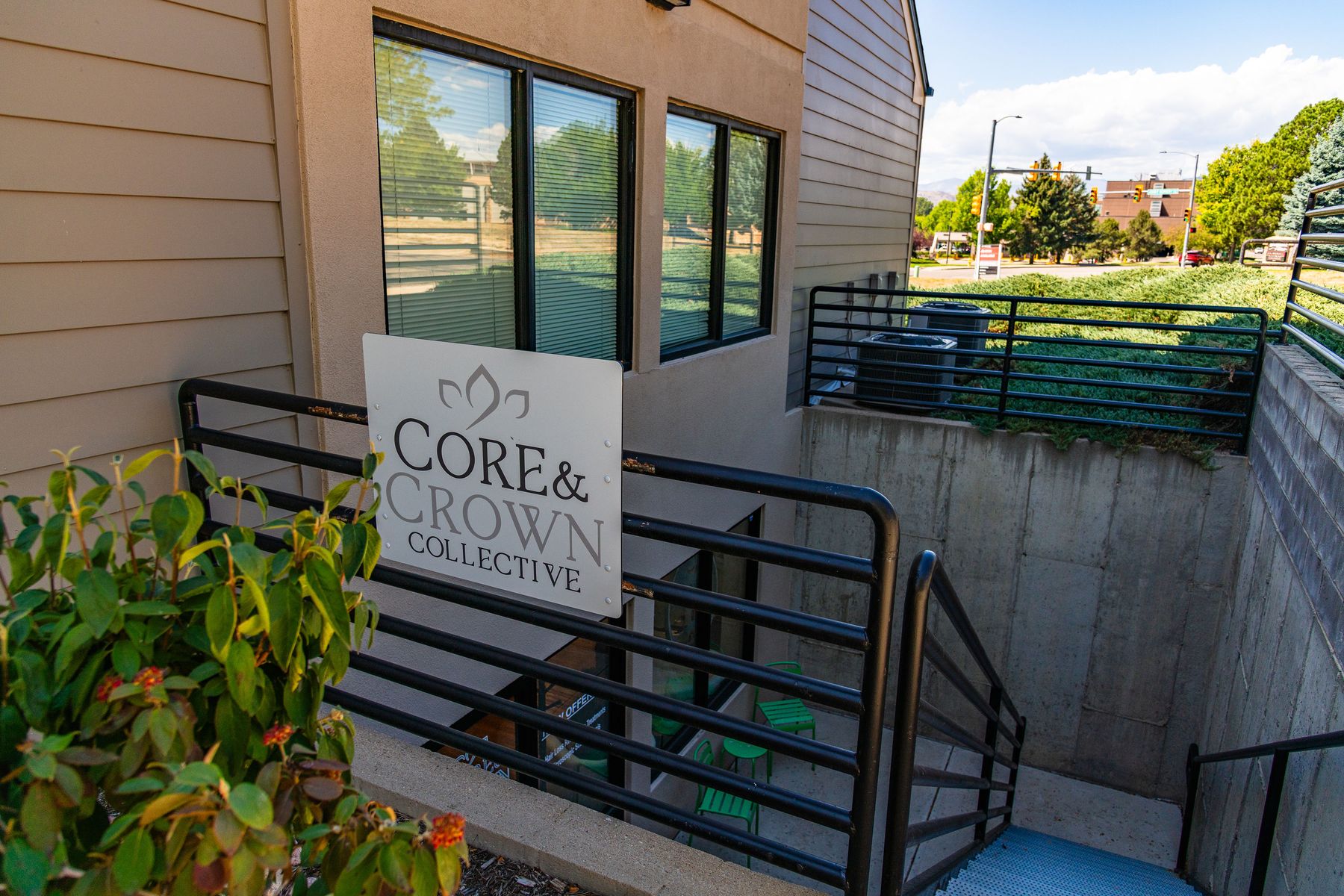 The Core & Crown Collective sign at the top of the stairwell leading down to the studio entrance